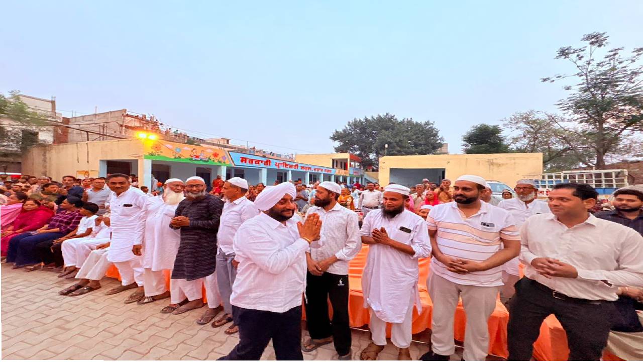 MLA Kulwant Singh interacting with residents during a community meeting in Jujhar Nagar, SAS Nagar Mohali, highlighting development initiatives and screening a documentary on Sri Guru Ravidas Ji.