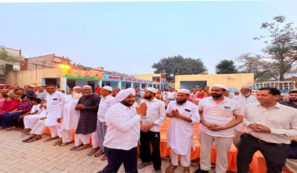 MLA Kulwant Singh interacting with residents during a community meeting in Jujhar Nagar, SAS Nagar Mohali, highlighting development initiatives and screening a documentary on Sri Guru Ravidas Ji.