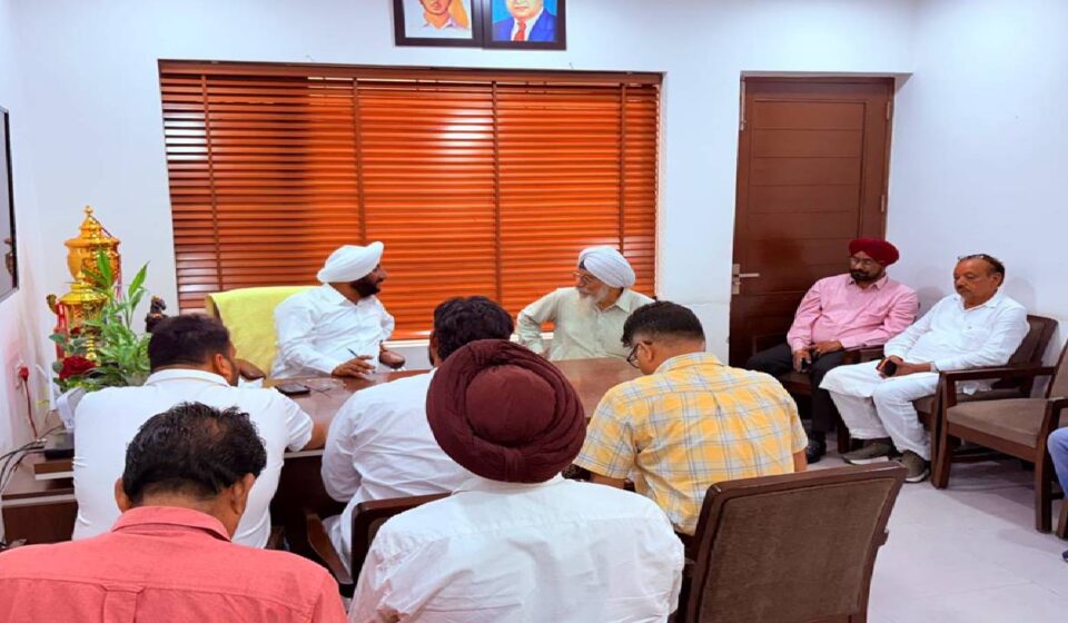 MLA Kulwant Singh interacting with residents during a public grievance meeting at his constituency office in Mohali.